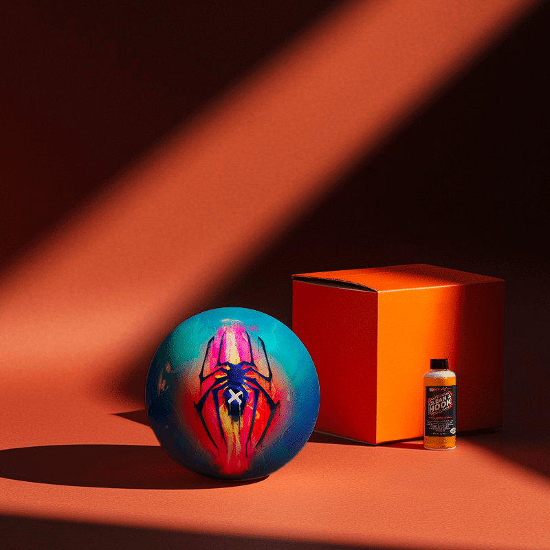 Hands holding a red orb with intricate, patterned artwork depicting a figure with sunglasses.