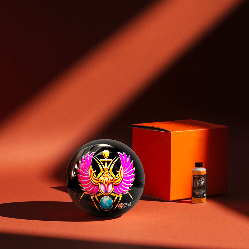 Hands holding a red orb with intricate, patterned artwork depicting a figure with sunglasses.