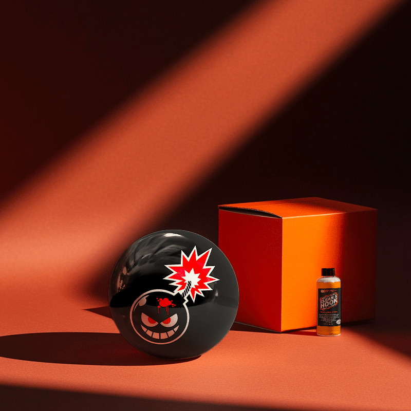 Hands holding a red orb with intricate, patterned artwork depicting a figure with sunglasses.