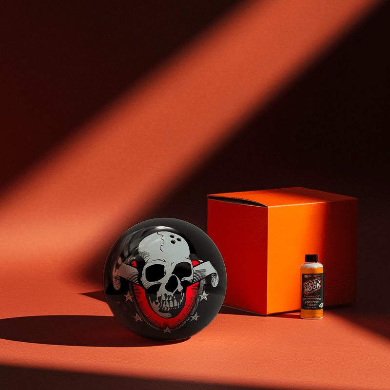 Hands holding a red orb with intricate, patterned artwork depicting a figure with sunglasses.