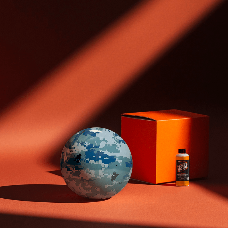 Hands holding a red orb with intricate, patterned artwork depicting a figure with sunglasses.