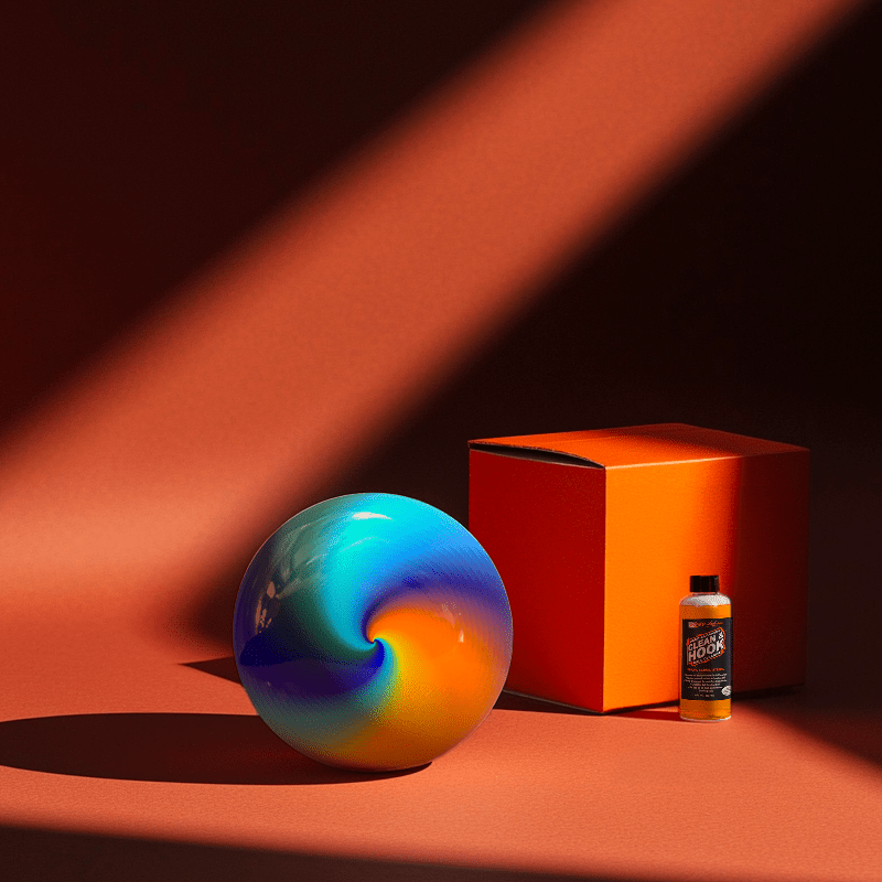 Hands holding a red orb with intricate, patterned artwork depicting a figure with sunglasses.