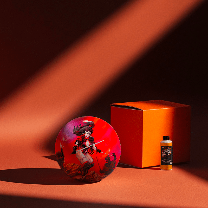 Hands holding a red orb with intricate, patterned artwork depicting a figure with sunglasses.