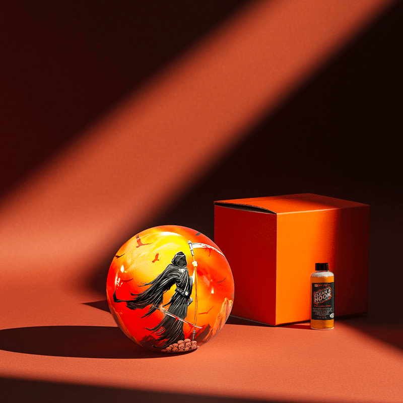 Hands holding a red orb with intricate, patterned artwork depicting a figure with sunglasses.