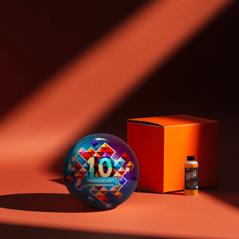 Hands holding a red orb with intricate, patterned artwork depicting a figure with sunglasses.