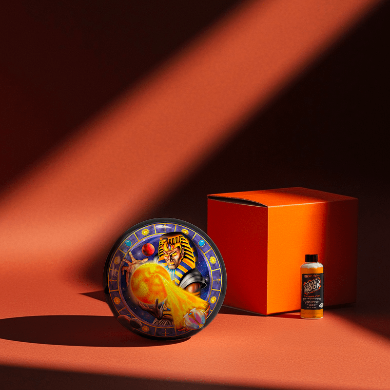 Hands holding a red orb with intricate, patterned artwork depicting a figure with sunglasses.