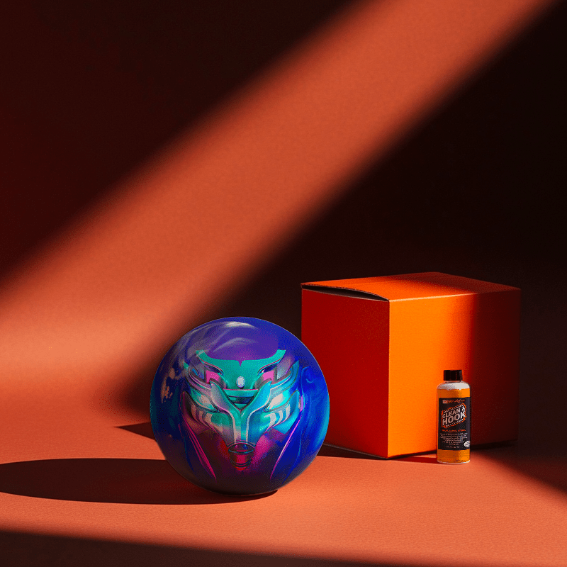 Hands holding a red orb with intricate, patterned artwork depicting a figure with sunglasses.