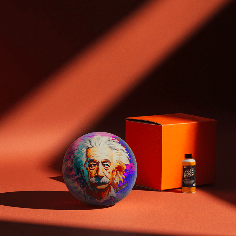 Hands holding a red orb with intricate, patterned artwork depicting a figure with sunglasses.