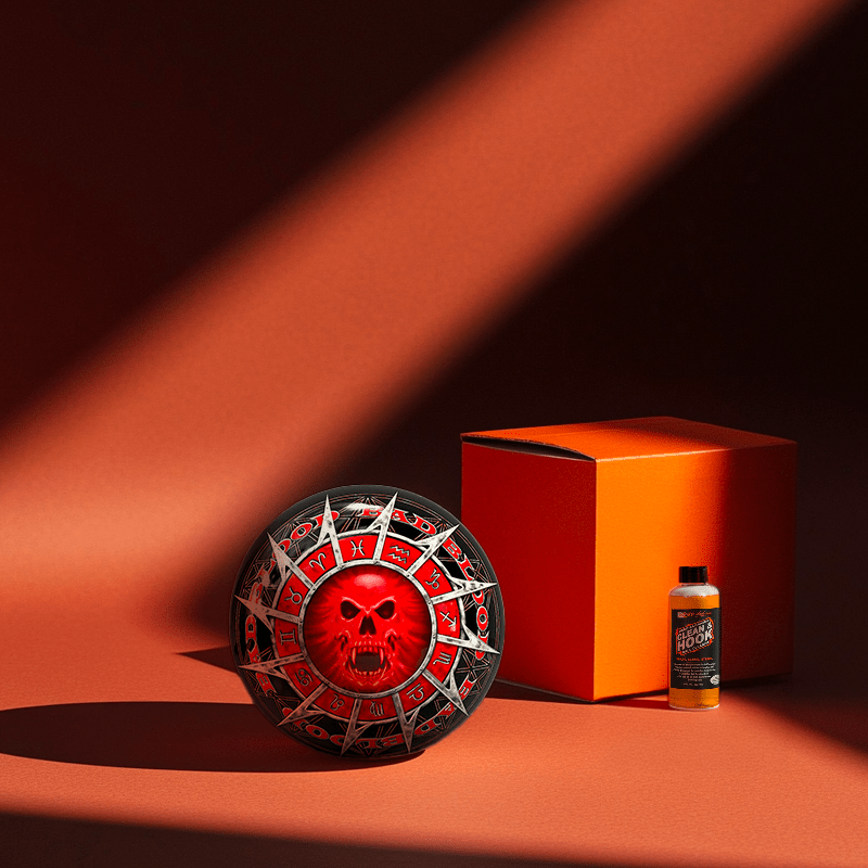 Hands holding a red orb with intricate, patterned artwork depicting a figure with sunglasses.