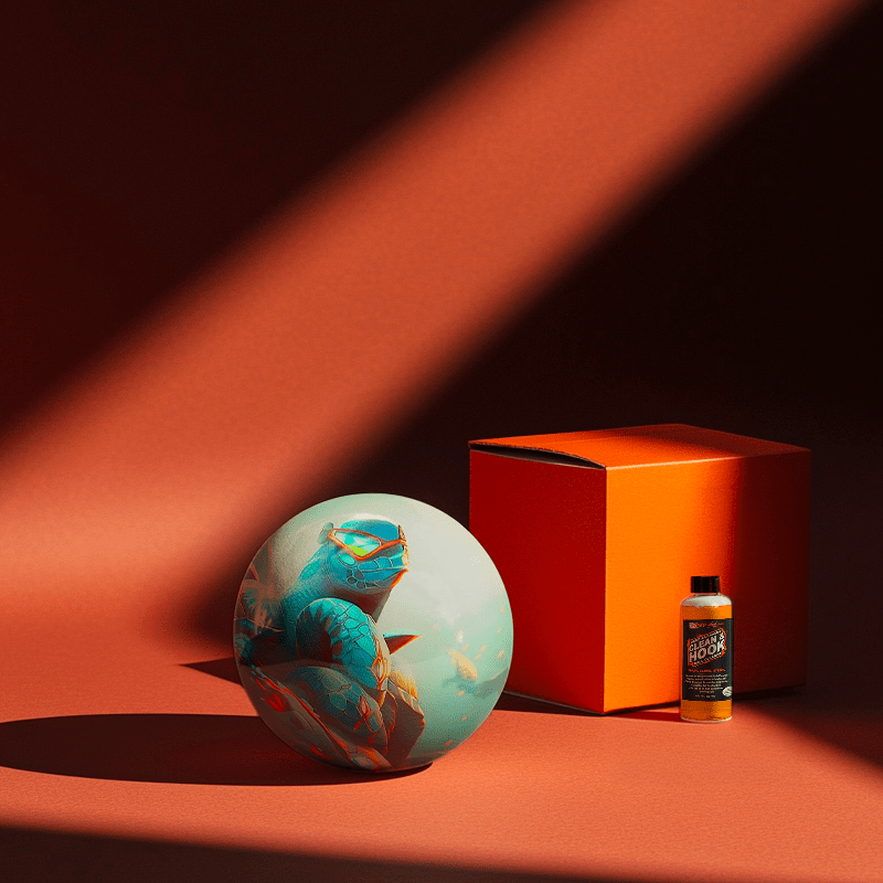 Hands holding a red orb with intricate, patterned artwork depicting a figure with sunglasses.