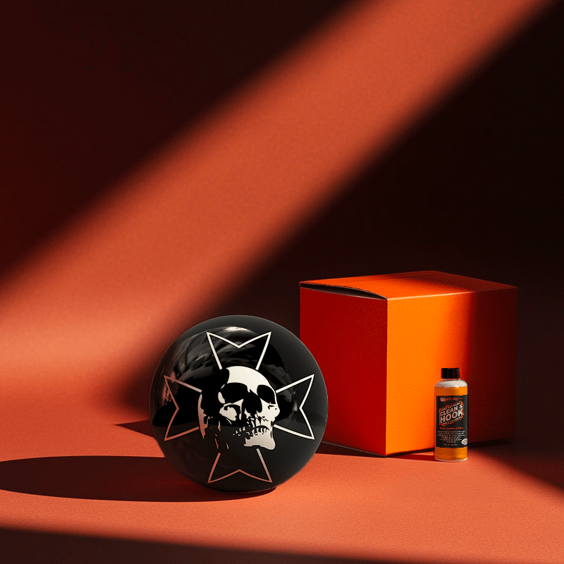 Hands holding a red orb with intricate, patterned artwork depicting a figure with sunglasses.