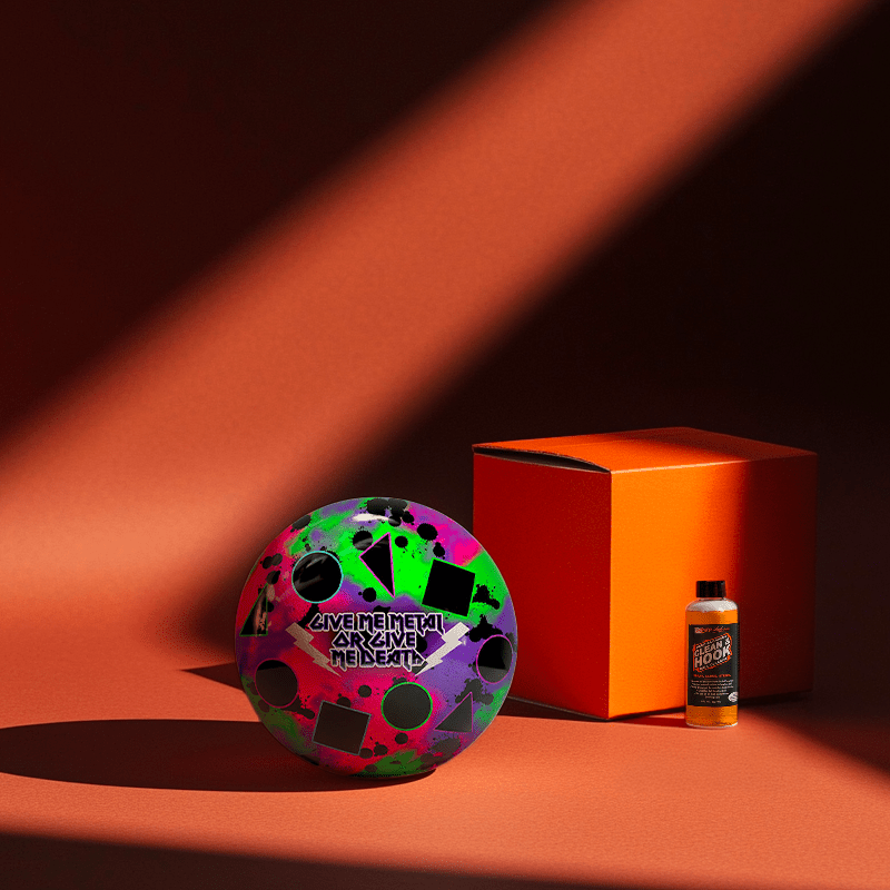 Hands holding a red orb with intricate, patterned artwork depicting a figure with sunglasses.