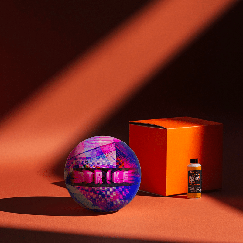 Hands holding a red orb with intricate, patterned artwork depicting a figure with sunglasses.