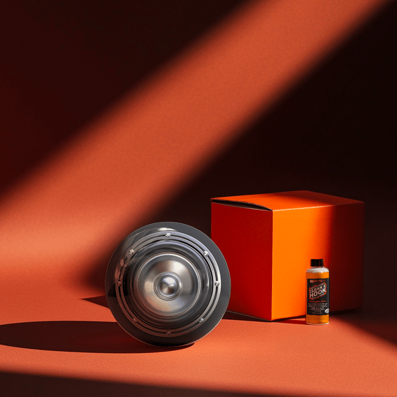 Hands holding a red orb with intricate, patterned artwork depicting a figure with sunglasses.