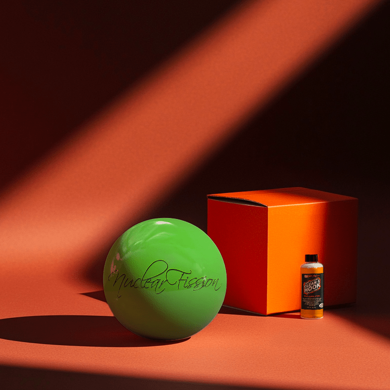 Hands holding a red orb with intricate, patterned artwork depicting a figure with sunglasses.