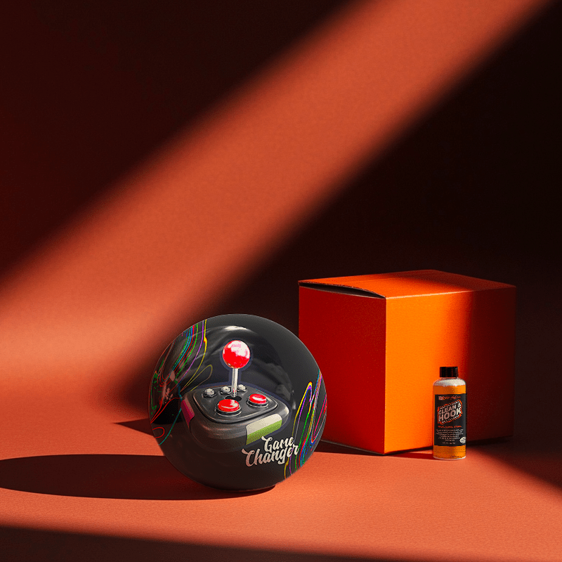 Hands holding a red orb with intricate, patterned artwork depicting a figure with sunglasses.