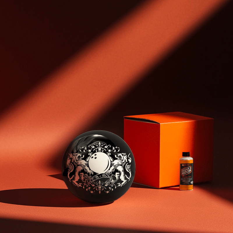 Hands holding a red orb with intricate, patterned artwork depicting a figure with sunglasses.