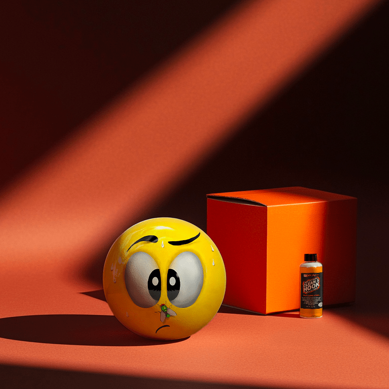 Hands holding a red orb with intricate, patterned artwork depicting a figure with sunglasses.