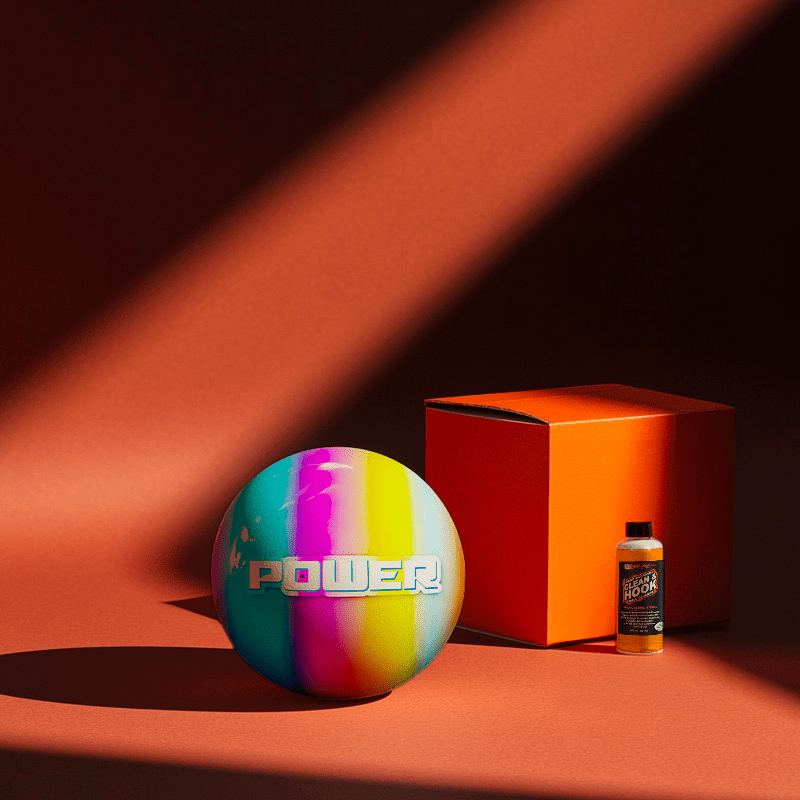 Hands holding a red orb with intricate, patterned artwork depicting a figure with sunglasses.