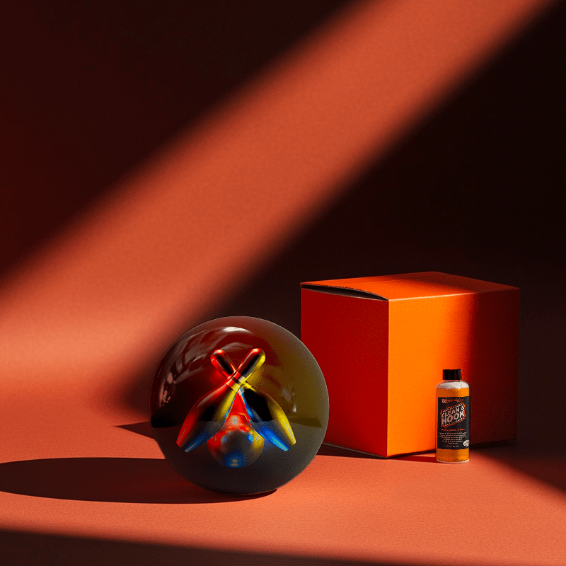 Hands holding a red orb with intricate, patterned artwork depicting a figure with sunglasses.