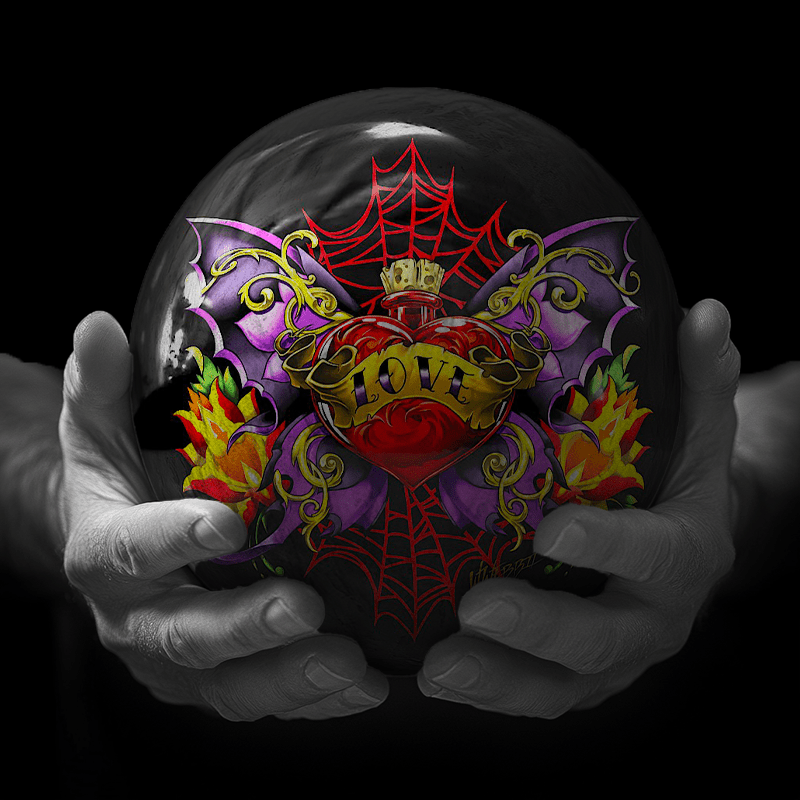 Hands holding a red sphere featuring a floral-patterned figure.