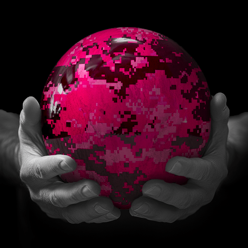 Hands holding a red sphere featuring a floral-patterned figure.