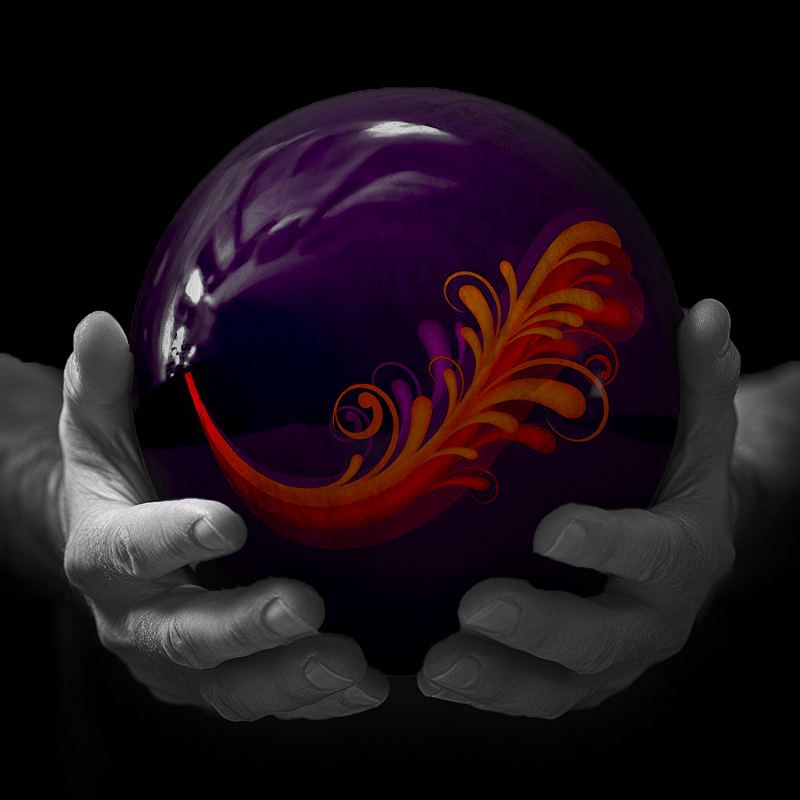 Hands holding a red sphere featuring a floral-patterned figure.