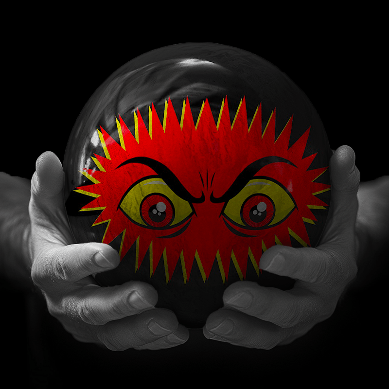 Hands holding a red sphere featuring a floral-patterned figure.