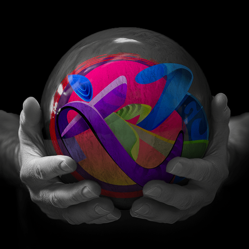 Hands holding a red sphere featuring a floral-patterned figure.